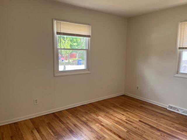 846 Hancock St SE, Grand Rapids, MI 49507 - empty room featuring plenty of natural light and wood finished floors