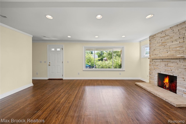643 Spencer St, Ferndale, MI 48220 - unfurnished living room featuring a stone fireplace, wood finished floors, crown molding, and recessed lighting