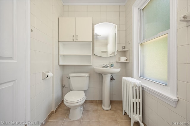 643 Spencer St, Ferndale, MI 48220 - bathroom with radiator heating unit, tile walls, and tile patterned flooring