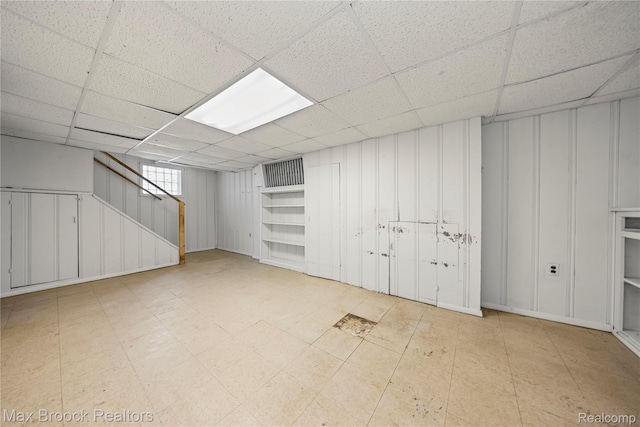 643 Spencer St, Ferndale, MI 48220 - below grade area with a paneled ceiling, a decorative wall, and stairs