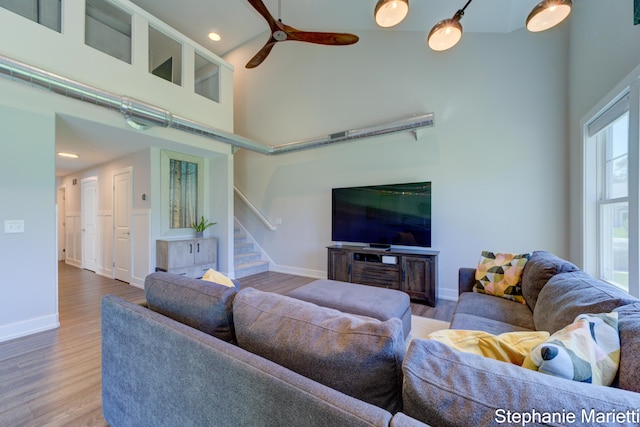 675 Terrace Point Dr, Muskegon, MI 49440 - living area featuring a towering ceiling, stairway, ceiling fan, wood finished floors, and recessed lighting