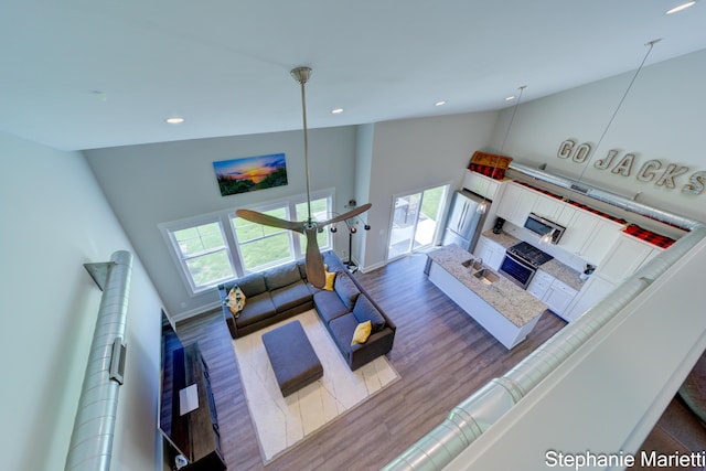 675 Terrace Point Dr, Muskegon, MI 49440 - living room with healthy amount of natural light, wood finished floors, high vaulted ceiling, and recessed lighting
