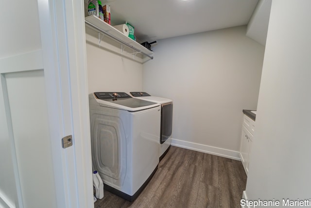 675 Terrace Point Dr, Muskegon, MI 49440 - washroom with washing machine and dryer, cabinet space, and dark wood finished floors