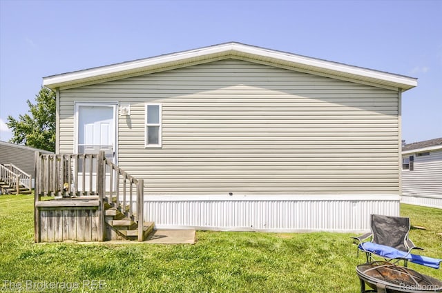 491 Harrison Dr, Davison, MI 48423 - back of property featuring a fire pit and a yard