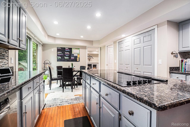 4469 Tanbark St, Bloomfield Hills, MI 48302 - kitchen with black electric cooktop, gray cabinets, recessed lighting, a kitchen island, and decorative backsplash