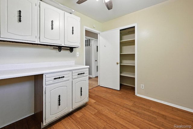 1935 Carmanbrook Pkwy, Flint, MI 48507 - kitchen featuring white cabinetry, light wood-style floors, light countertops, and ceiling fan
