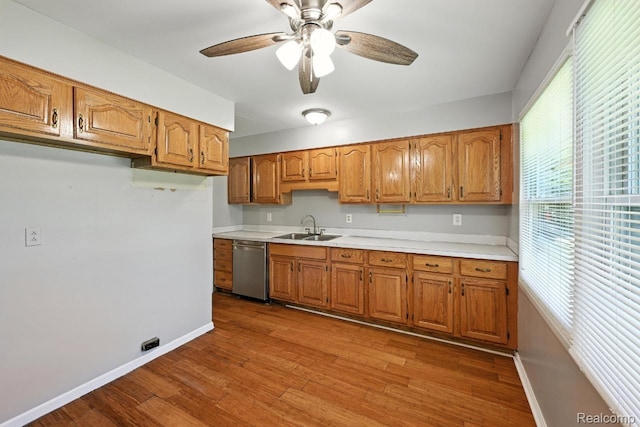 1935 Carmanbrook Pkwy, Flint, MI 48507 - kitchen featuring stainless steel dishwasher, light countertops, brown cabinetry, and ceiling fan