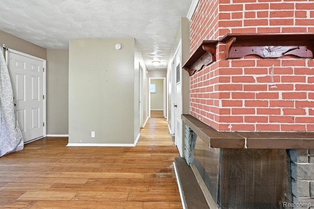 1935 Carmanbrook Pkwy, Flint, MI 48507 - corridor featuring wood finished floors and a textured ceiling