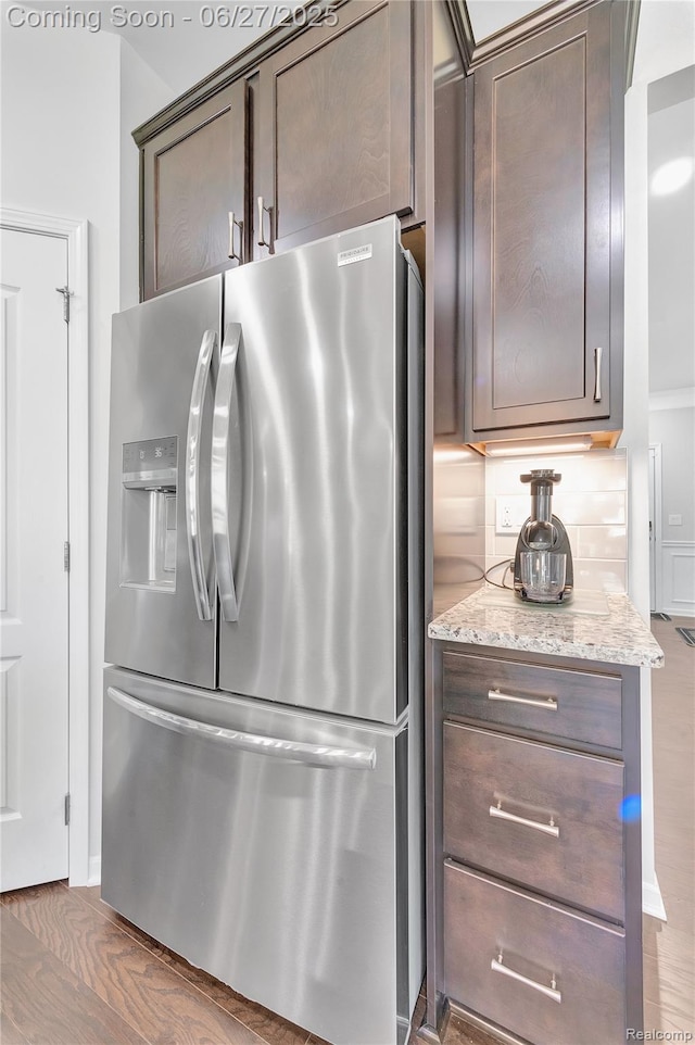 38731 Chasewood Ct, Farmington Hills, MI 48335 - kitchen with stainless steel fridge with ice dispenser, dark brown cabinetry, light stone countertops, and wood finished floors