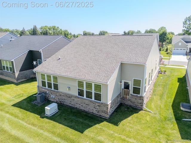 38731 Chasewood Ct, Farmington Hills, MI 48335 - back of property with brick siding, a yard, and a shingled roof