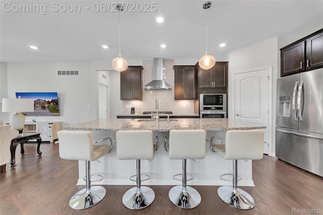 38731 Chasewood Ct, Farmington Hills, MI 48335 - kitchen with wall chimney exhaust hood, appliances with stainless steel finishes, dark brown cabinetry, dark wood-style floors, and recessed lighting