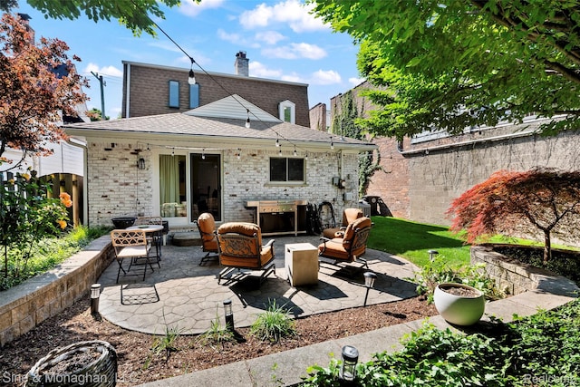 389 Kercheval Ave, Grosse Pointe, MI 48236 - rear view of house with a patio area, brick siding, a chimney, an outdoor hangout area, and roof with shingles