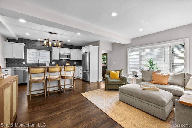 389 Kercheval Ave, Grosse Pointe, MI 48236 - living room with dark wood finished floors, recessed lighting, and a chandelier