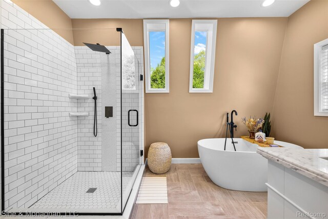 389 Kercheval Ave, Grosse Pointe, MI 48236 - bathroom featuring a stall shower, a freestanding bath, recessed lighting, and vanity
