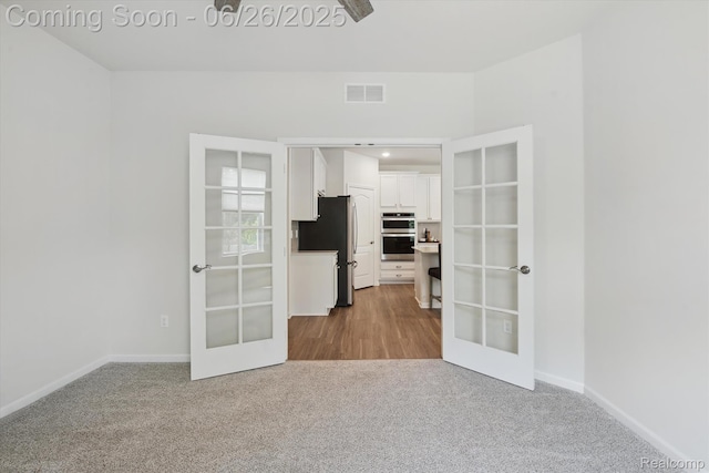 1065 Spring Trail Ct, Brighton, MI 48116 - unfurnished room featuring french doors and carpet floors