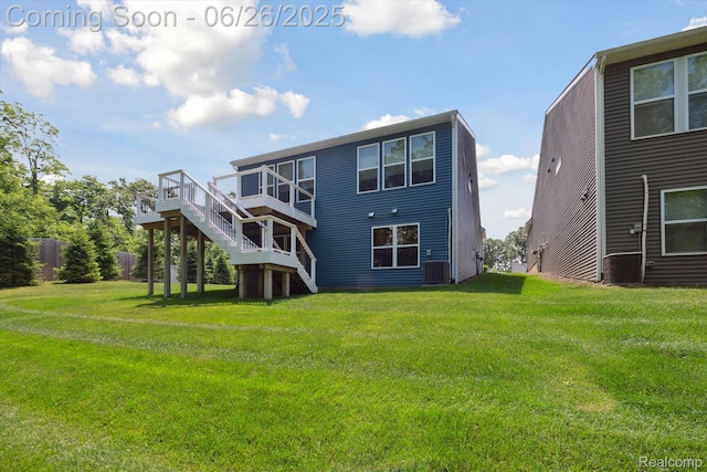 1065 Spring Trail Ct, Brighton, MI 48116 - rear view of property with stairway, a yard, and a wooden deck