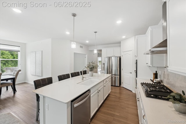 1065 Spring Trail Ct, Brighton, MI 48116 - kitchen featuring appliances with stainless steel finishes, wall chimney exhaust hood, a kitchen breakfast bar, backsplash, and recessed lighting