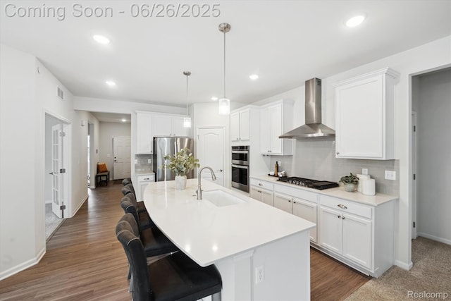 1065 Spring Trail Ct, Brighton, MI 48116 - kitchen featuring wall chimney range hood, stainless steel appliances, backsplash, a breakfast bar, and white cabinetry