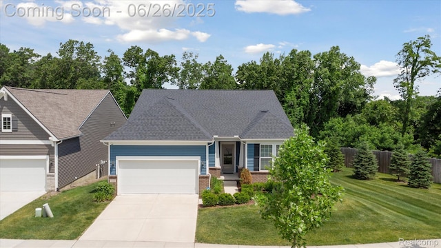 1065 Spring Trail Ct, Brighton, MI 48116 - view of front facade with concrete driveway, an attached garage, and brick siding