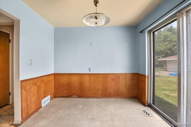 4663 Marian Ave, Warren, MI 48092 - unfurnished room featuring wainscoting, wood walls, and light floors