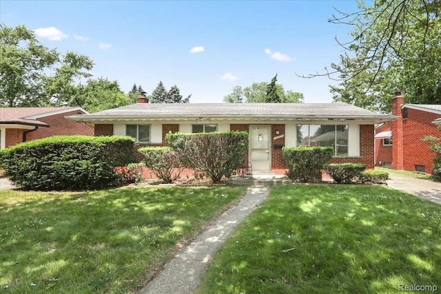4663 Marian Ave, Warren, MI 48092 - view of front of home with brick siding, a chimney, and a front yard