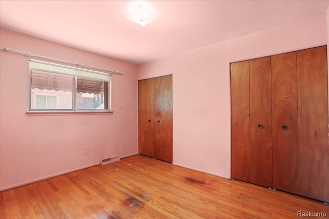 4663 Marian Ave, Warren, MI 48092 - unfurnished bedroom featuring two closets and light wood-style floors