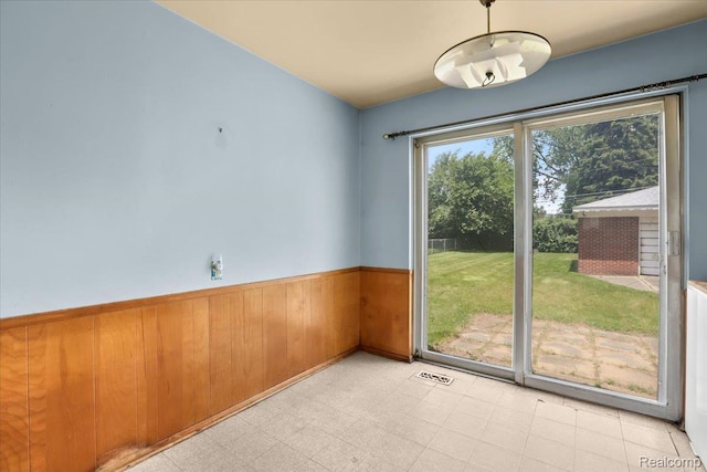 4663 Marian Ave, Warren, MI 48092 - spare room featuring a wainscoted wall, wood walls, and light flooring