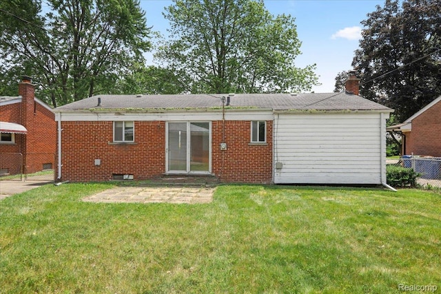 4663 Marian Ave, Warren, MI 48092 - back of house featuring brick siding, a patio, and a chimney