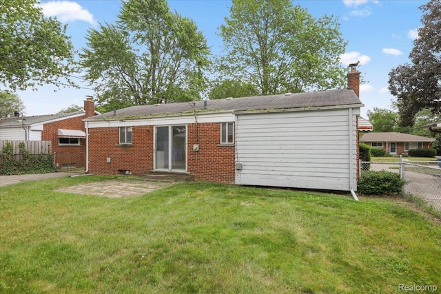 4663 Marian Ave, Warren, MI 48092 - back of property featuring a chimney, brick siding, and a patio