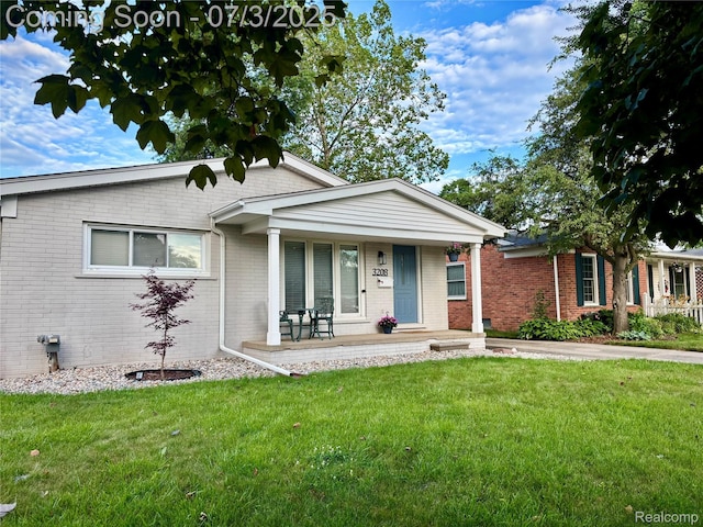 3208 Clawson Ave, Royal Oak, MI 48073 - view of front of home featuring brick siding, covered porch, and a front yard