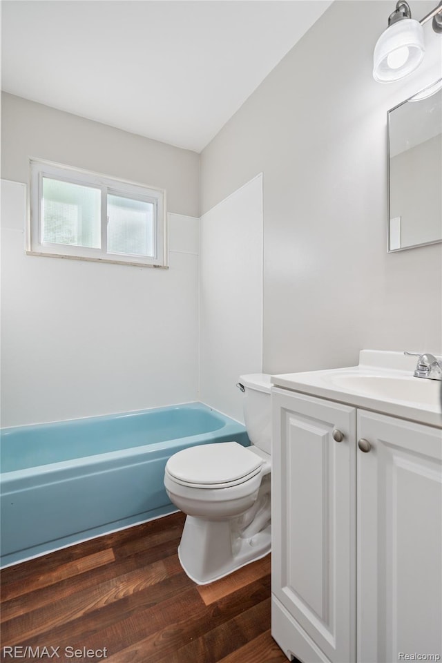 3062 Walton Ave, Davison, MI 48504 - full bathroom with vanity, a tub, and wood finished floors