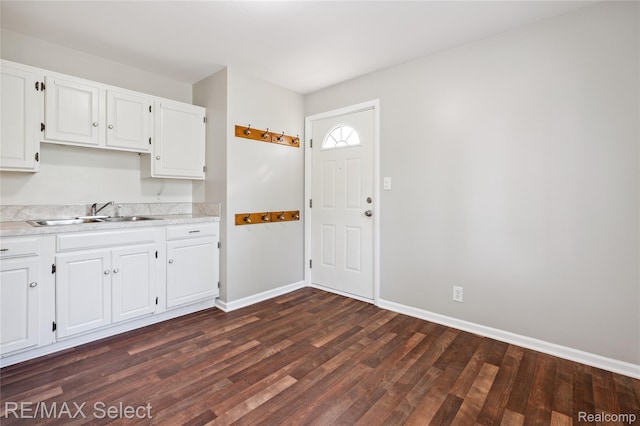 3062 Walton Ave, Davison, MI 48504 - kitchen featuring dark wood-type flooring, light countertops, and white cabinetry