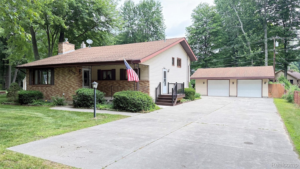 3752 Grant Ave, Fort Gratiot, MI 48059 - view of front of home with an outdoor structure, a chimney, a garage, and brick siding