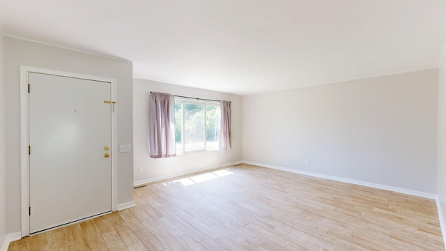 7106 Partridge Dr, Flushing, MI 48433 - spare room with light wood finished floors and baseboards