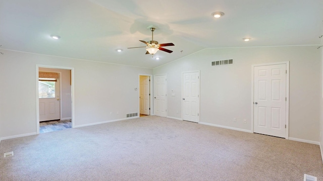 7106 Partridge Dr, Flushing, MI 48433 - unfurnished bedroom with light colored carpet, vaulted ceiling, two closets, recessed lighting, and ceiling fan