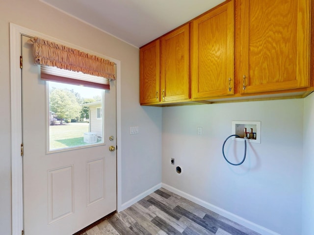 7106 Partridge Dr, Flushing, MI 48433 - washroom featuring cabinet space, washer hookup, light wood finished floors, and electric dryer hookup