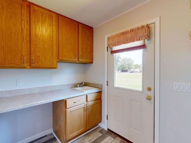 7106 Partridge Dr, Flushing, MI 48433 - kitchen with light countertops, light wood finished floors, and brown cabinetry