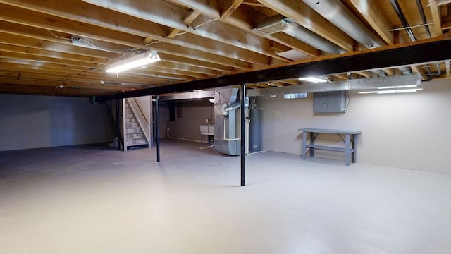 7106 Partridge Dr, Flushing, MI 48433 - below grade area with stairway, electric panel, gas water heater, and heating unit