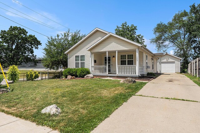 1449 Marquette St SW, Wyoming, MI 49509 - view of front of house with covered porch, driveway, and a detached garage