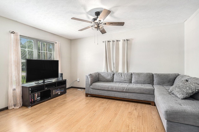 1449 Marquette St SW, Wyoming, MI 49509 - living room with wood finished floors, a ceiling fan, and a textured ceiling