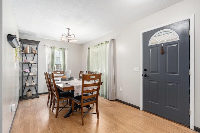 1449 Marquette St SW, Wyoming, MI 49509 - dining room featuring a chandelier and light wood-style flooring