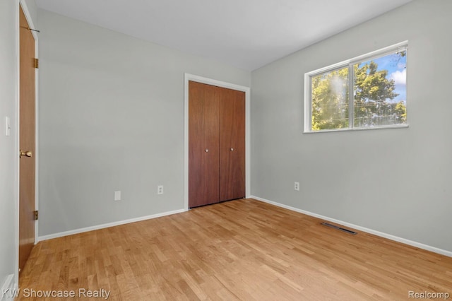 3196 Red Barn Rd, Flint, MI 48507 - unfurnished bedroom with light wood-type flooring and a closet