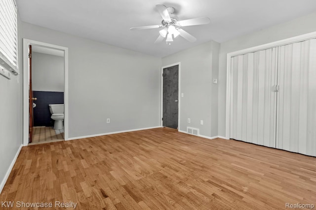3196 Red Barn Rd, Flint, MI 48507 - unfurnished bedroom featuring light wood finished floors, ensuite bathroom, and a ceiling fan