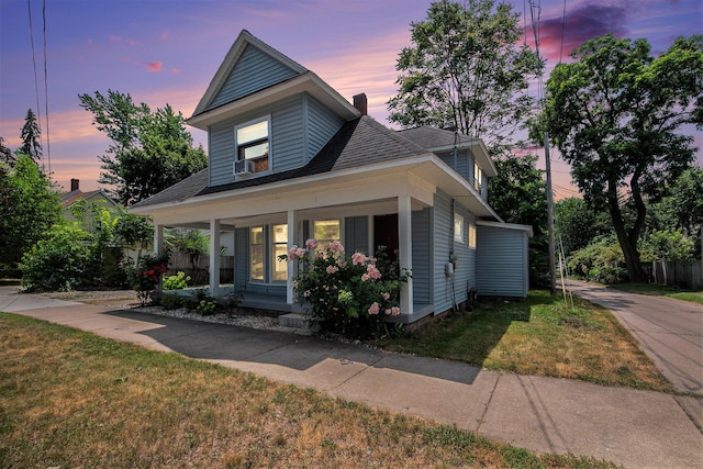 814 12th St NW, Grand Rapids, MI 49504 - view of front of house featuring a porch, a chimney, and a lawn