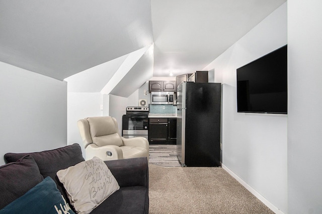 814 12th St NW, Grand Rapids, MI 49504 - living room featuring light carpet and lofted ceiling