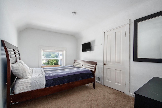 814 12th St NW, Grand Rapids, MI 49504 - carpeted bedroom featuring lofted ceiling