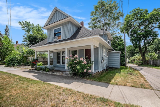 814 12th St NW, Grand Rapids, MI 49504 - bungalow-style house with covered porch, a front lawn, a chimney, and roof with shingles