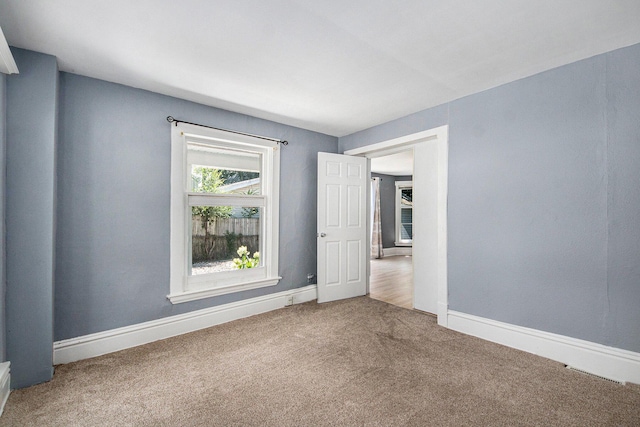 814 12th St NW, Grand Rapids, MI 49504 - unfurnished room featuring carpet flooring and baseboards