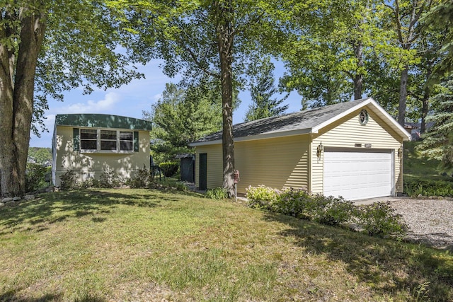12963 E Englewright Dr, Sand Lake, MI 49343 - view of front of property with a garage, an outbuilding, and a front lawn
