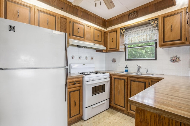 12963 E Englewright Dr, Sand Lake, MI 49343 - kitchen featuring white appliances, under cabinet range hood, and brown cabinets